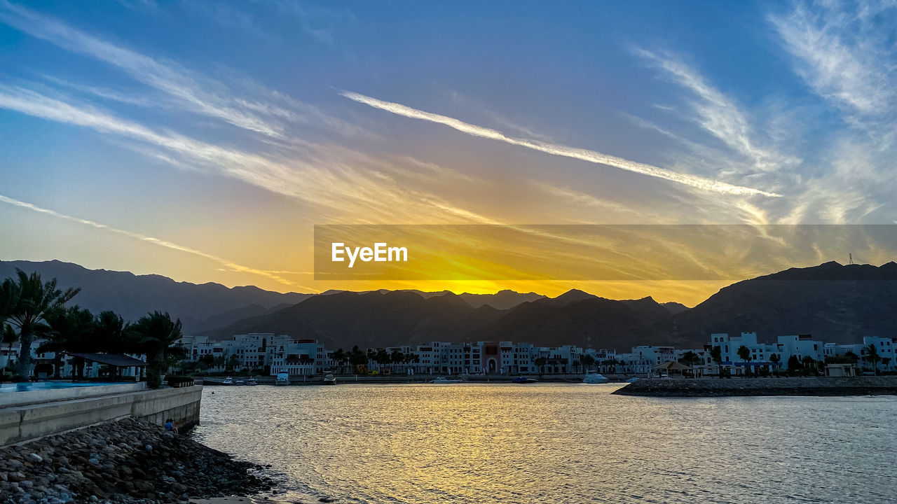 sky, water, mountain, sunset, dusk, sea, nature, scenics - nature, cloud, beauty in nature, horizon, evening, travel destinations, architecture, landscape, reflection, no people, environment, land, travel, mountain range, tranquility, blue, nautical vessel, coast, shore, tranquil scene, transportation, outdoors, city, sunlight, ocean, beach, tourism, sun, bay, built structure, tree, idyllic