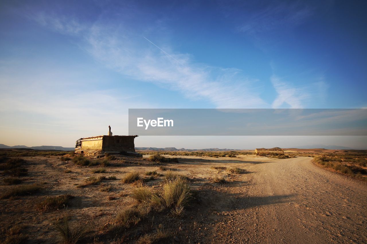 Lifeguard hut on landscape against sky