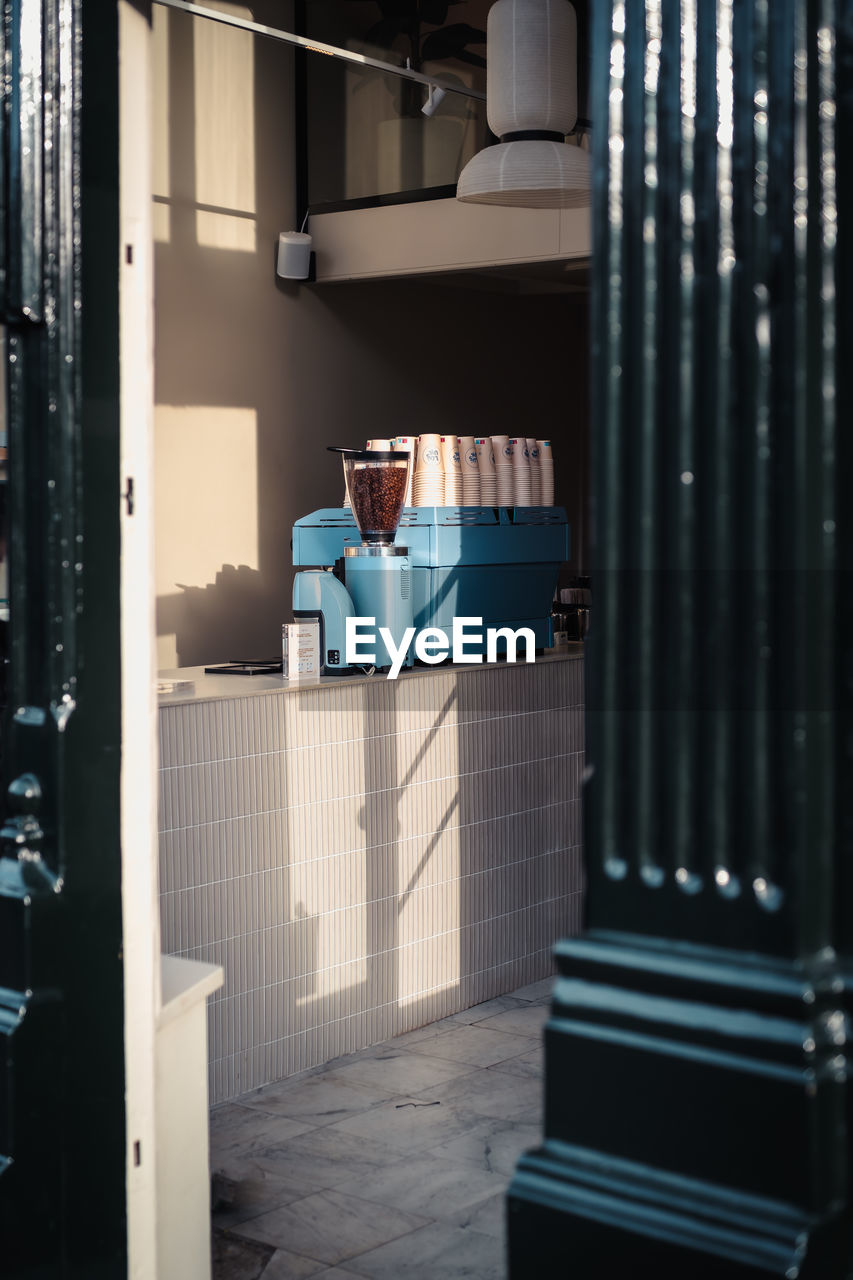 View through the door into a cafe with focus on the coffee machine and no people