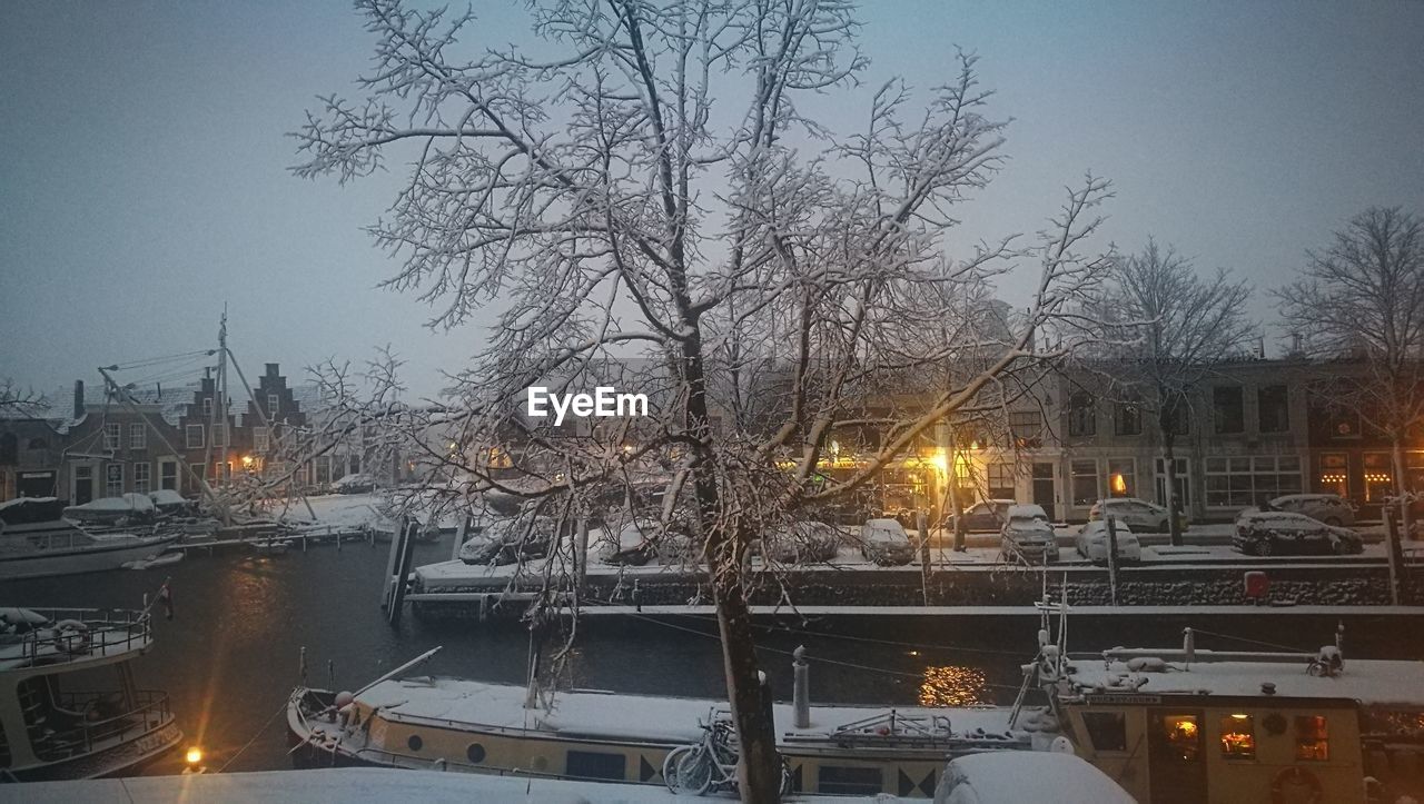 VIEW OF RIVER IN CITY AT NIGHT