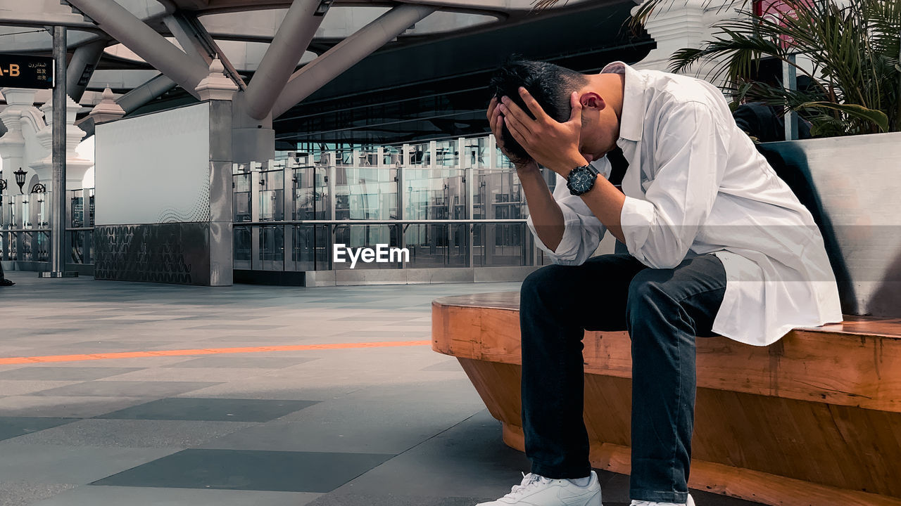 Depressed man sitting on the bench