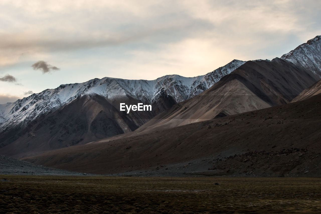 Scenic view of mountains against sky during sunset