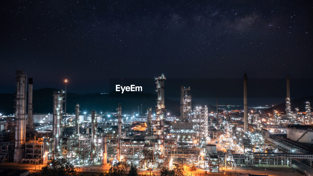 Oil and gas refinery plant or petrochemical industry at night sky and milky way background