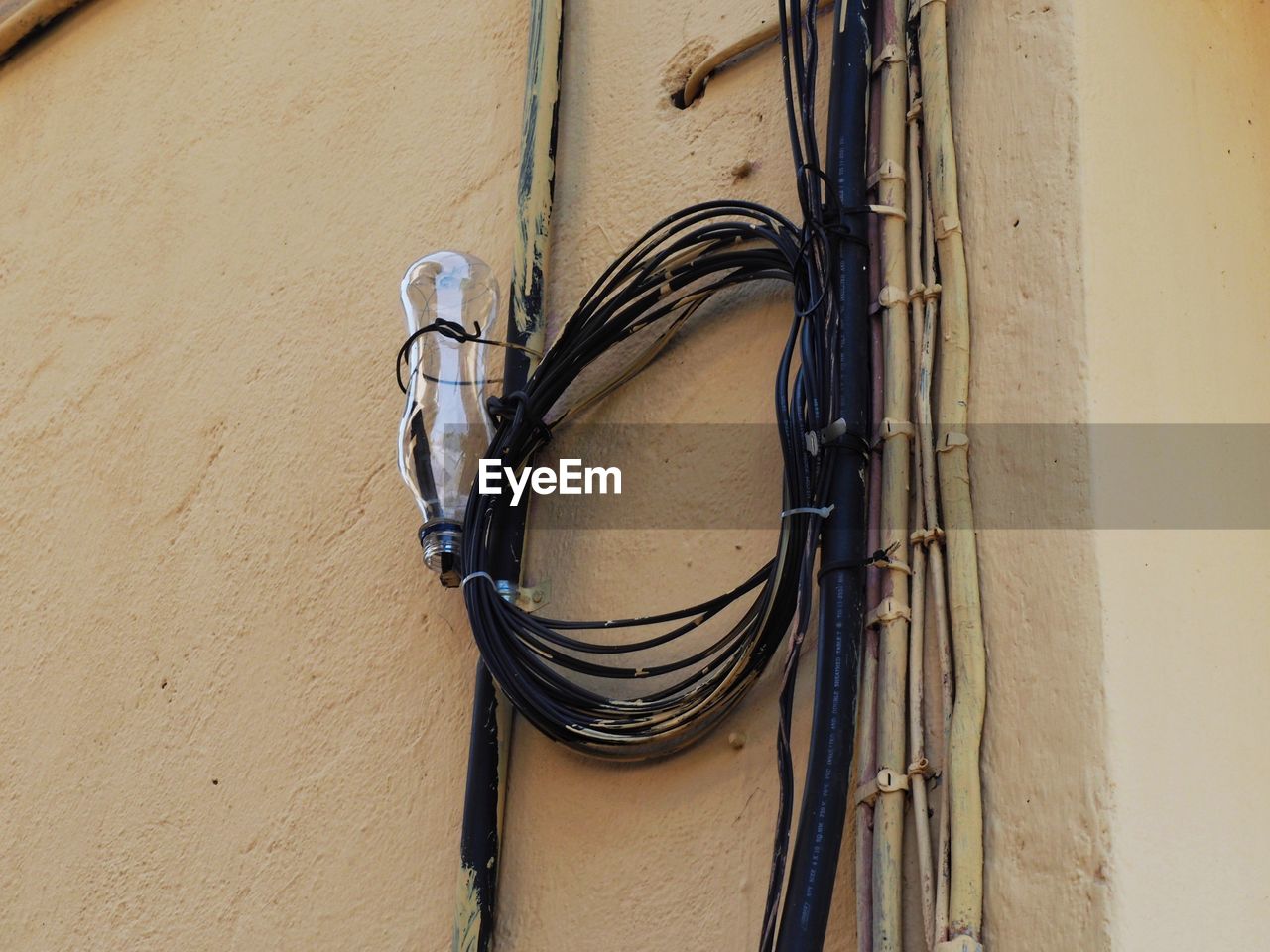 LOW ANGLE VIEW OF CHAIN HANGING ON WALL