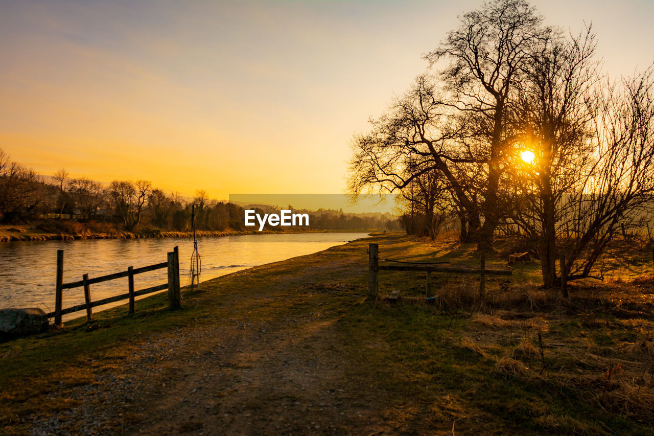 Scenic view of river against sky during sunset