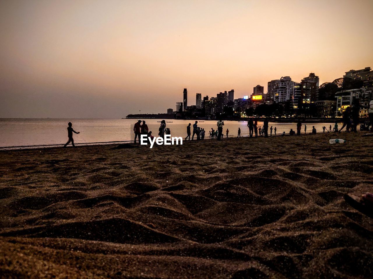 PEOPLE ON BEACH AT SUNSET