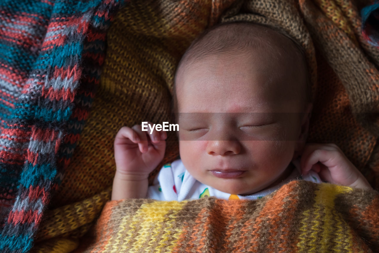 Close-up of cute baby sleeping at home