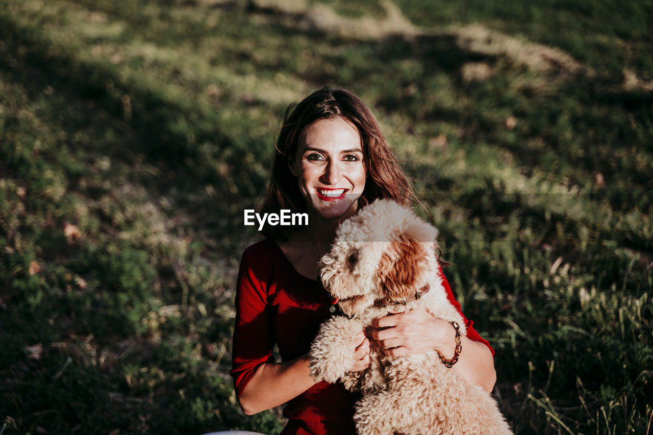 Portrait of smiling woman with dog