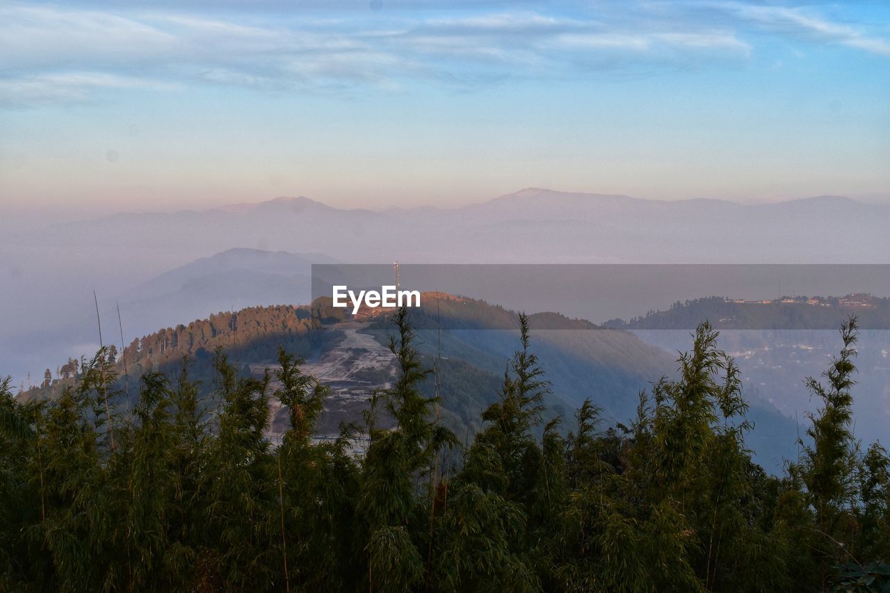 Scenic view of mountains against sky at sunset