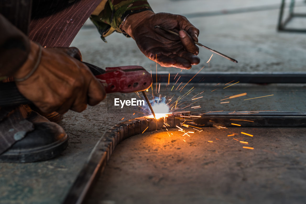 Low angle view of welder welding in workshop