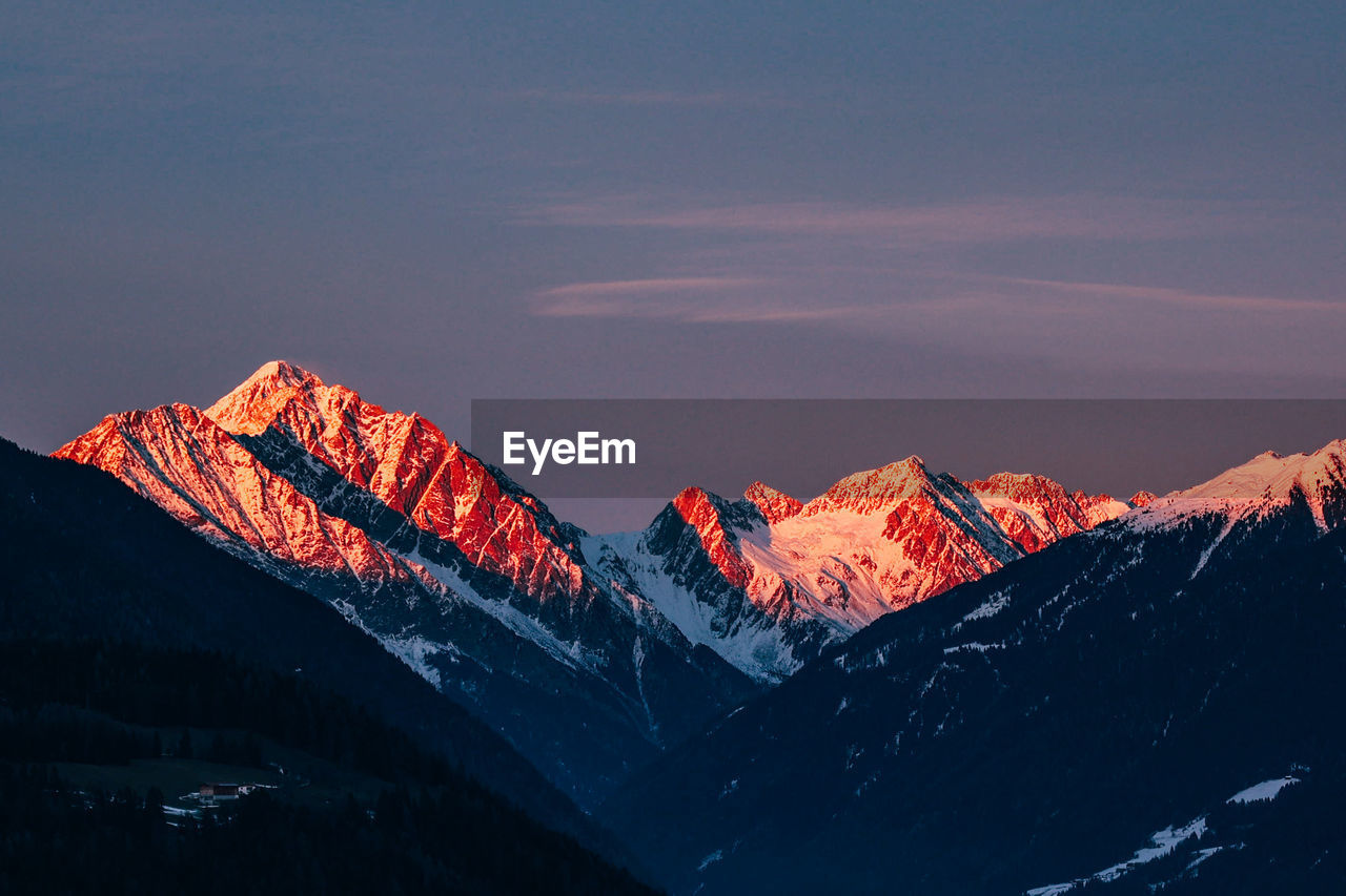 Scenic view of snowcapped mountains against sky during sunset in italian alps