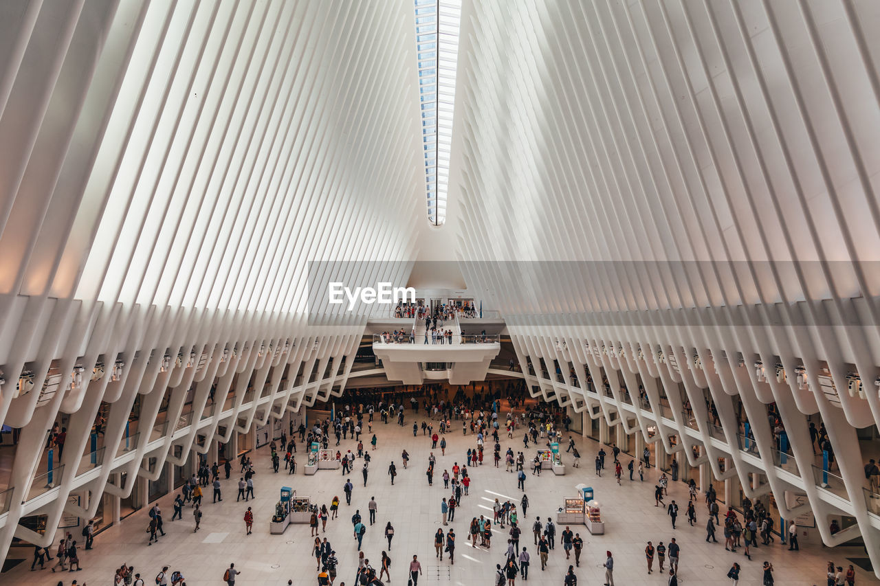 HIGH ANGLE VIEW OF PEOPLE ON MODERN BUILDING