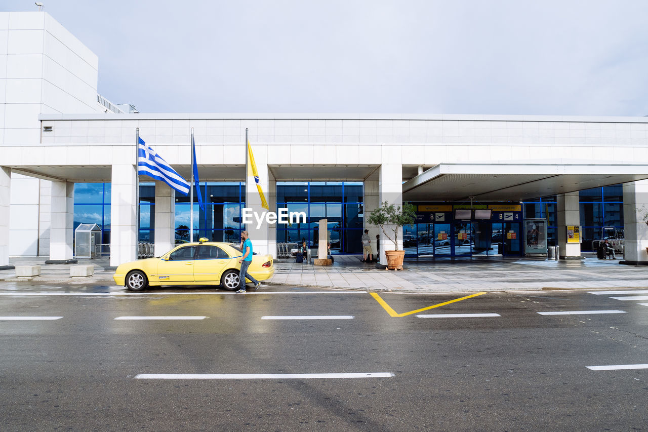 Taxi outside athens international airport against sky