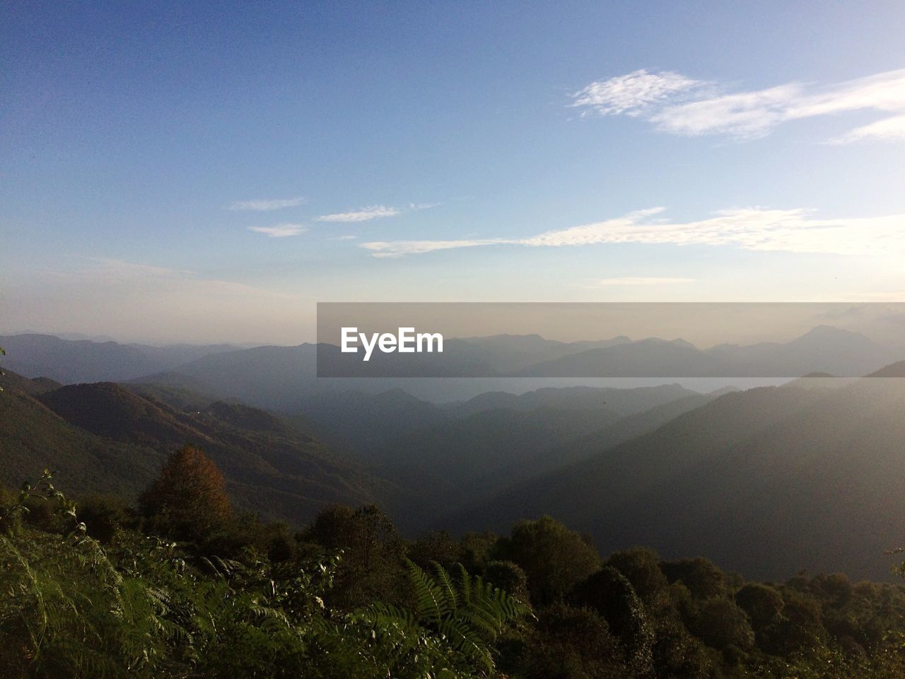 Scenic view of mountains against cloudy sky