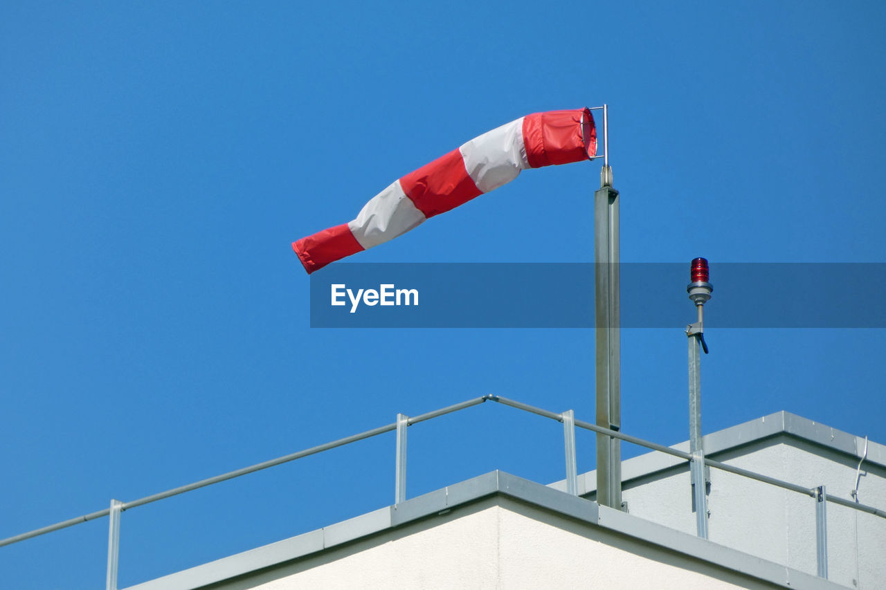 LOW ANGLE VIEW OF FLAGS AGAINST CLEAR SKY