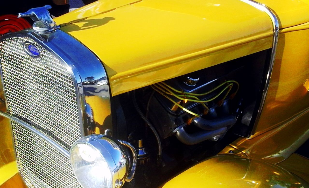 CLOSE-UP OF YELLOW CAR ON ROAD