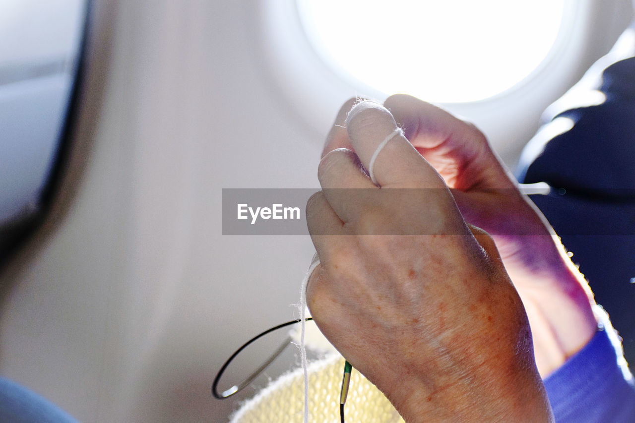 Woman on plane knitting