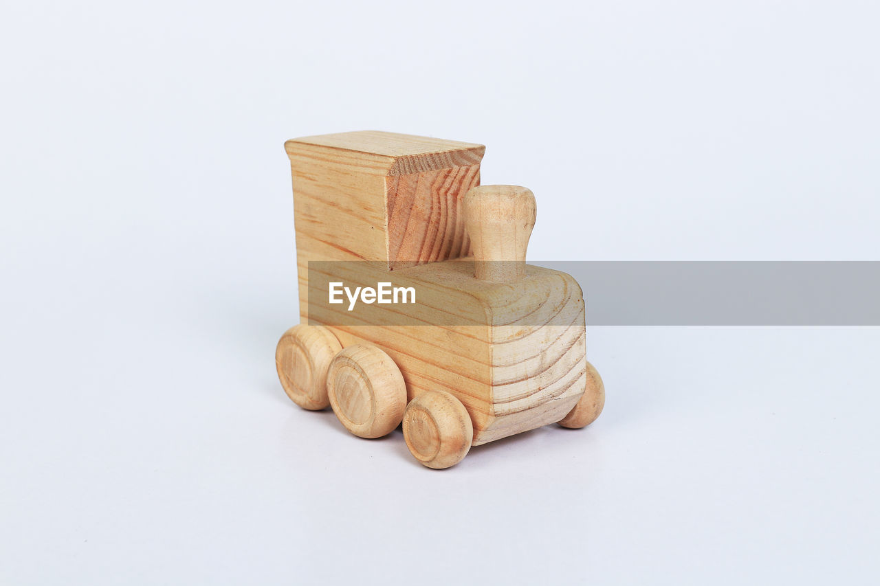 Close-up of wooden toy vehicle against white background