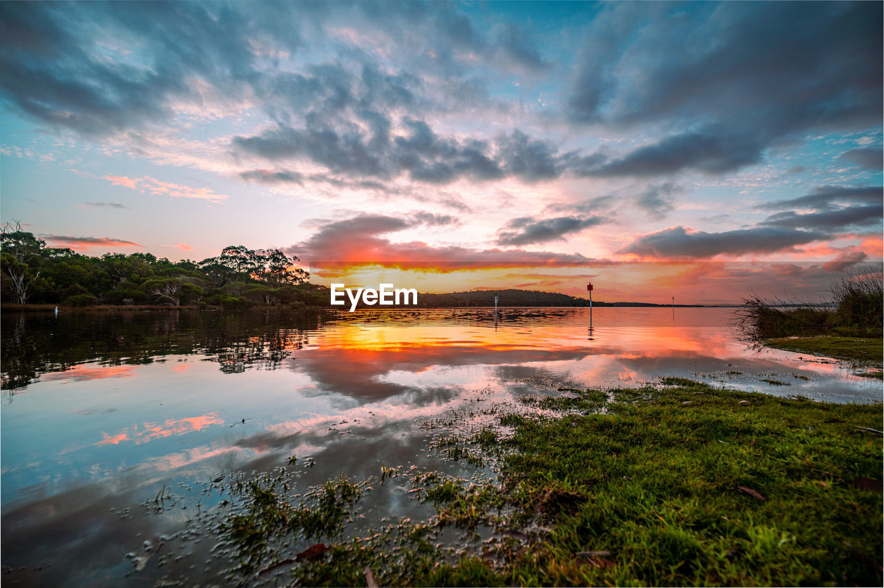 SCENIC VIEW OF LAKE AT SUNSET