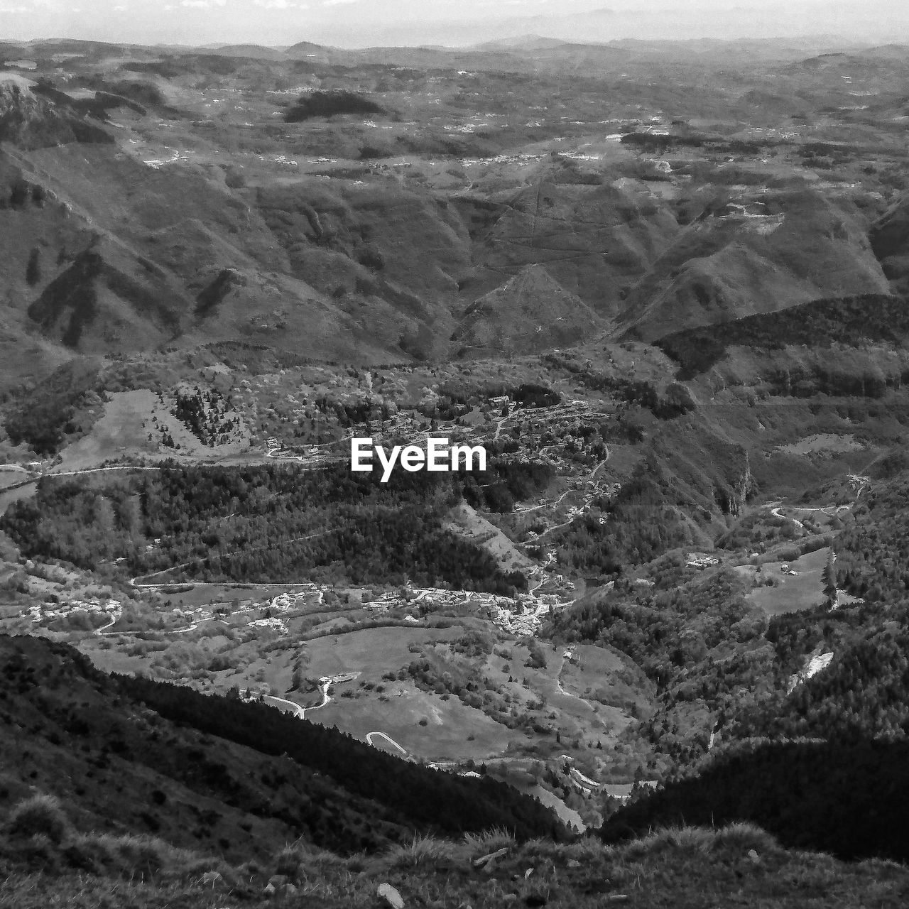 HIGH ANGLE VIEW OF ARID LANDSCAPE AND MOUNTAINS