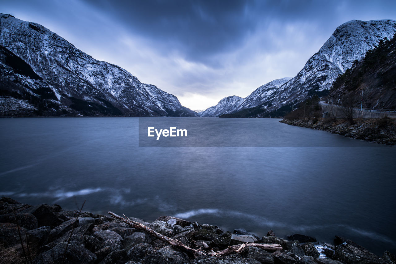 Scenic view of lake and mountains against sky