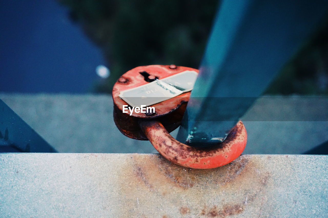 Close-up of padlock attached to railing