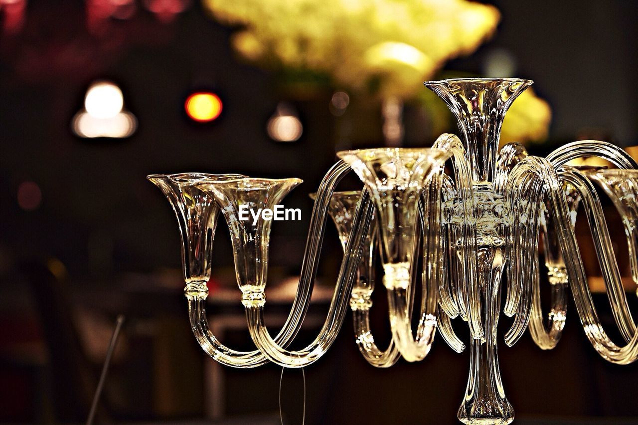 Close-up of chandelier candle holders against blurred background