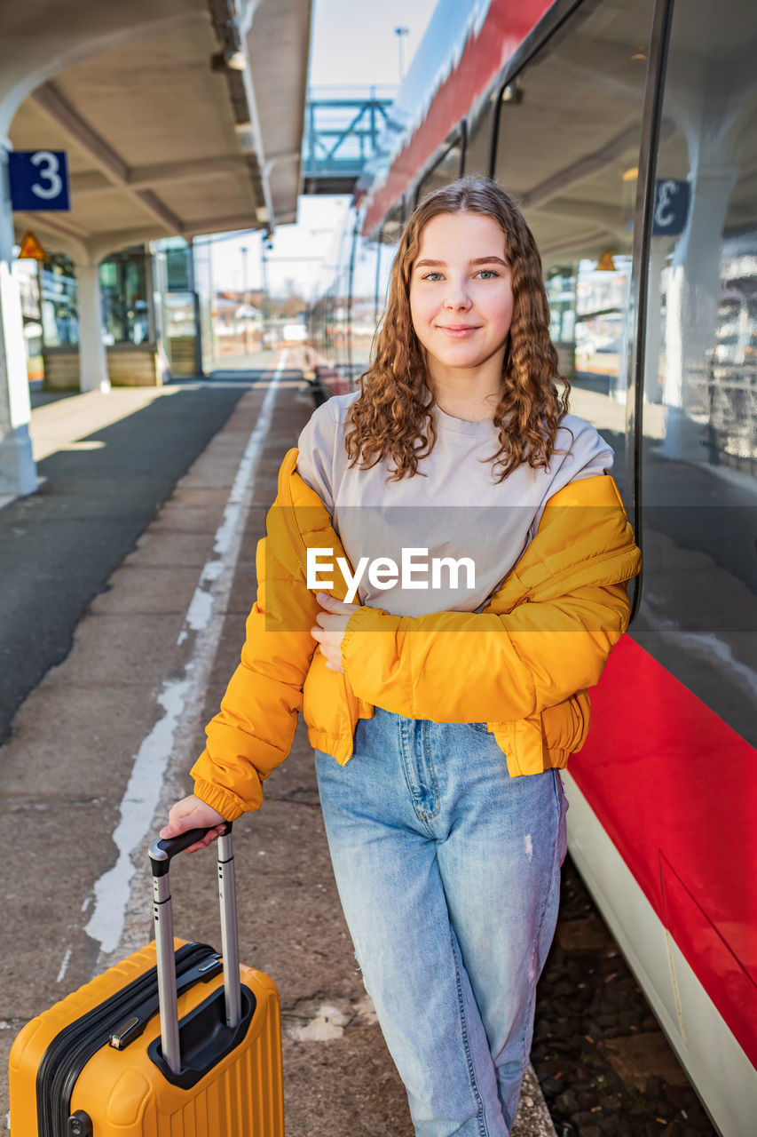 Portrait of woman standing in bus