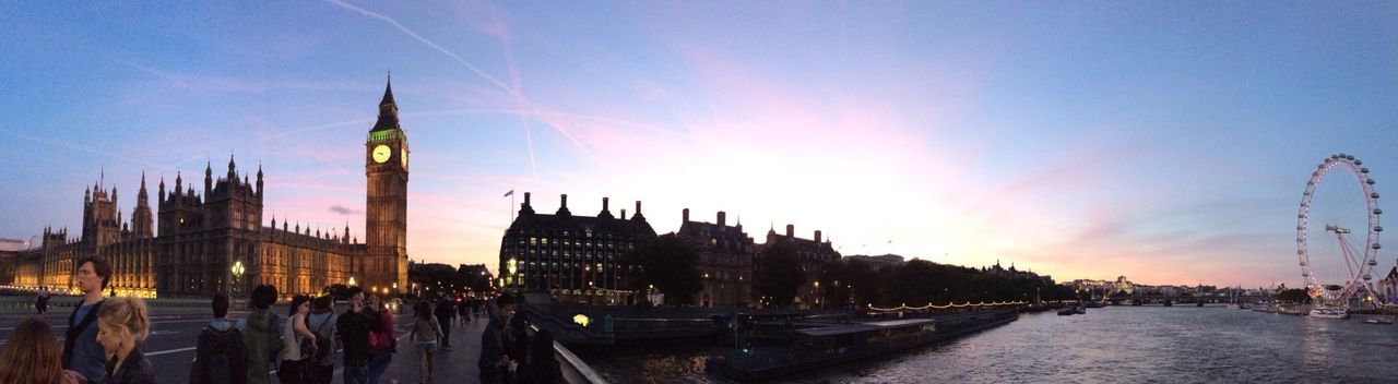 Panoramic shot of big ben with thames river and millennium wheel against sky during sunset