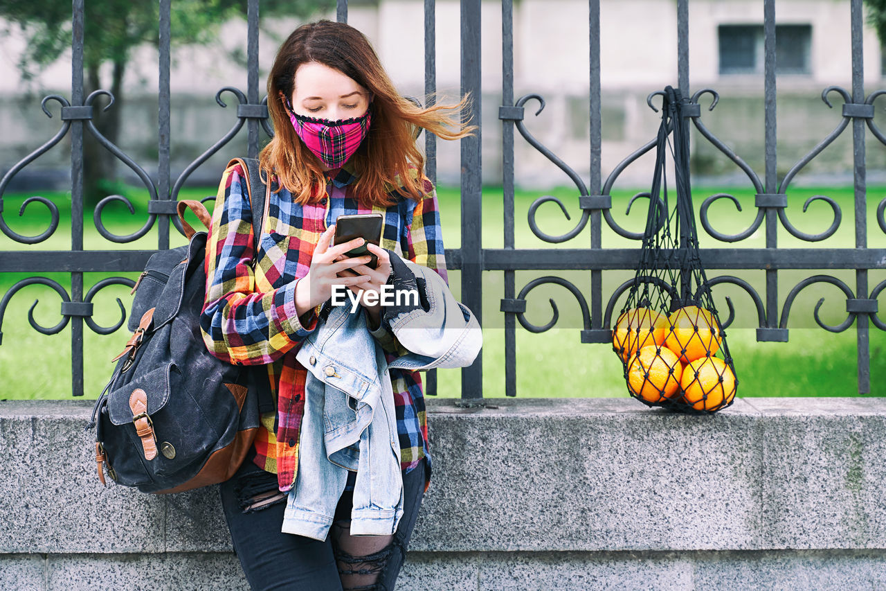 portrait of young woman using mobile phone
