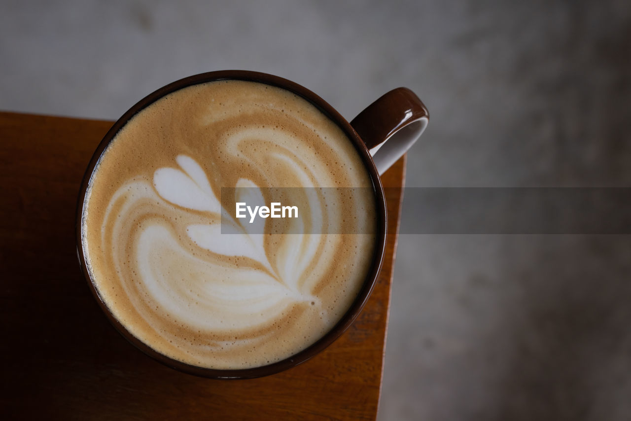 coffee, drink, refreshment, coffee cup, food and drink, frothy drink, cup, mug, cappuccino, latte, still life, froth art, hot drink, indoors, table, heart shape, creativity, close-up, no people, flat white, freshness, wood, food, cortado, crockery, cafe, directly above, spoon, kitchen utensil, coffee milk, saucer, love