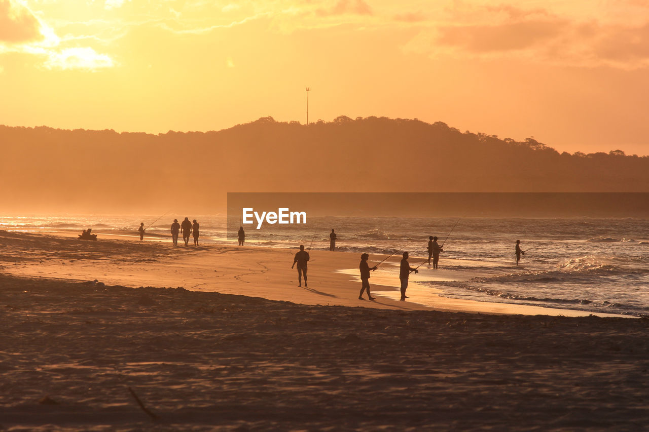 SILHOUETTE PEOPLE AT BEACH DURING SUNSET