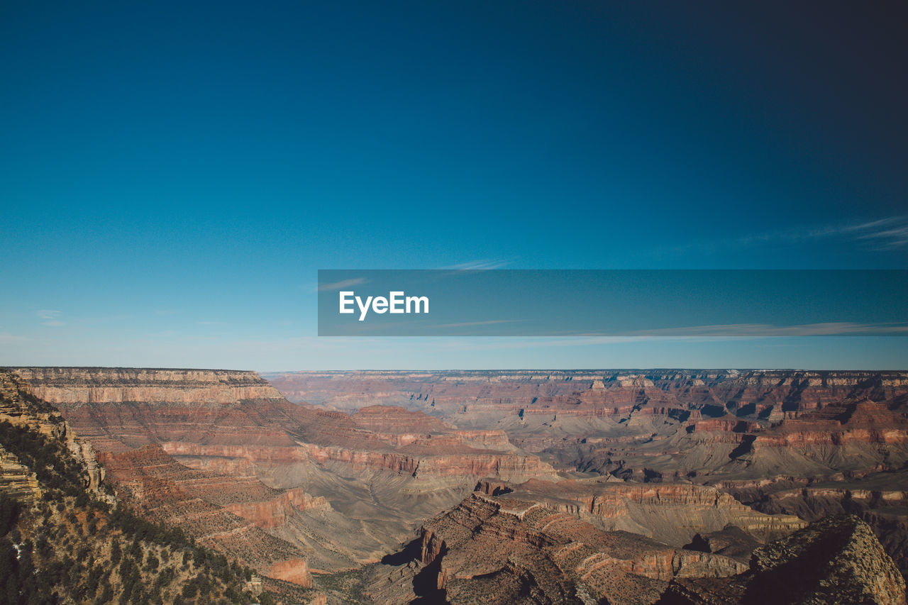 Scenic view of landscape against blue sky