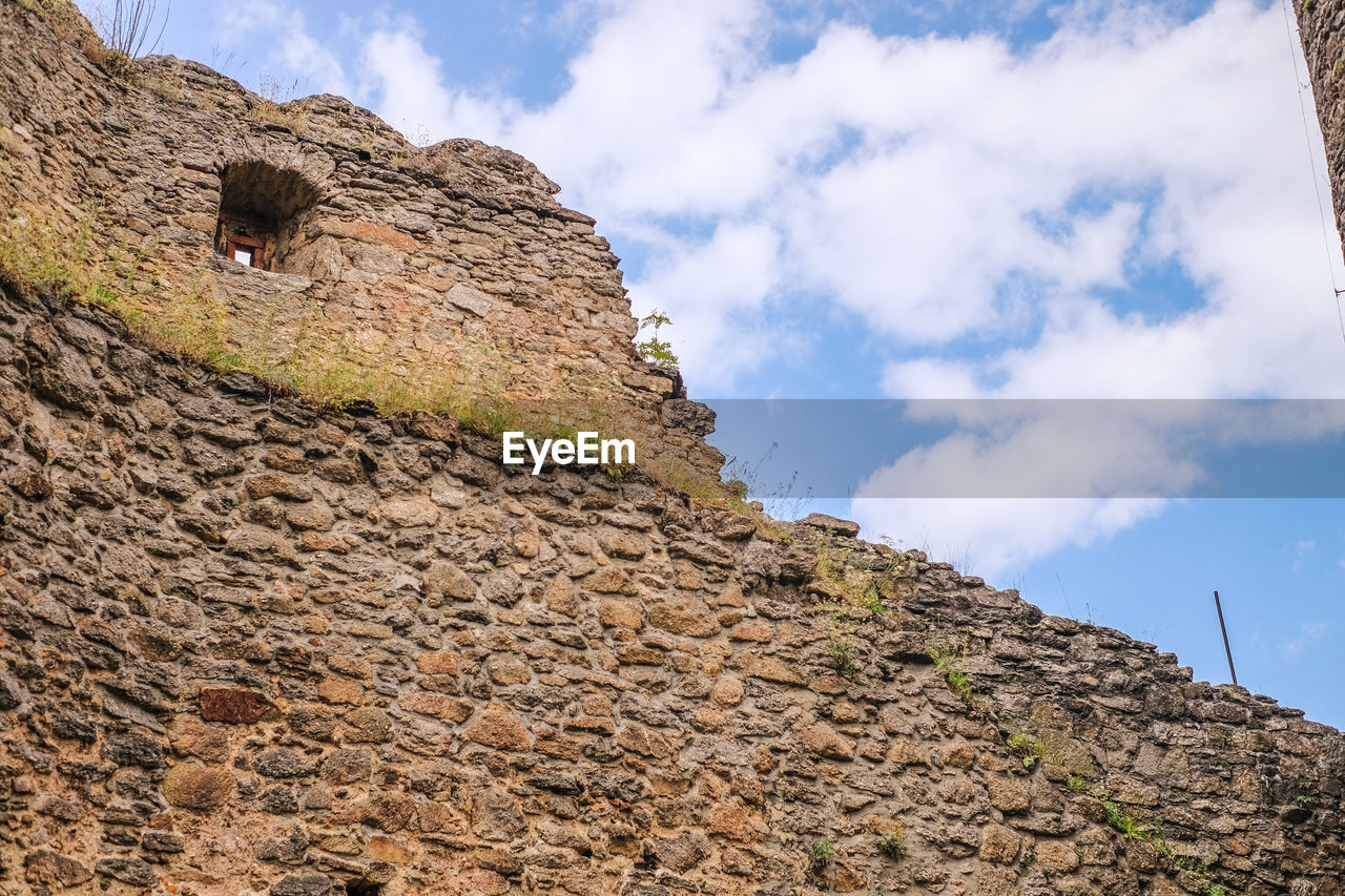 Low angle view of rock formations against sky