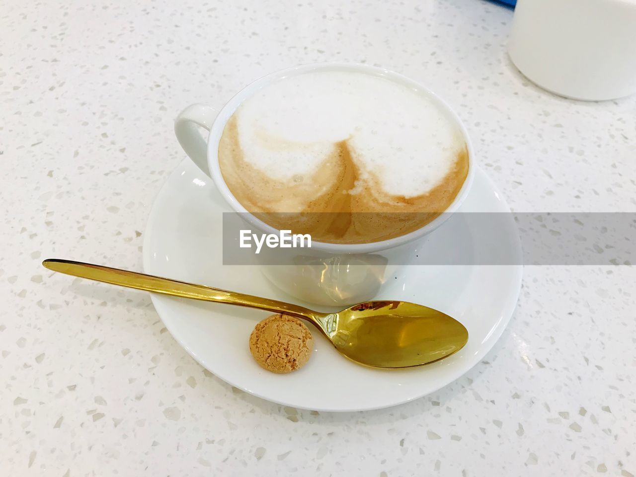 High angle view of cappuccino in a white cup on table