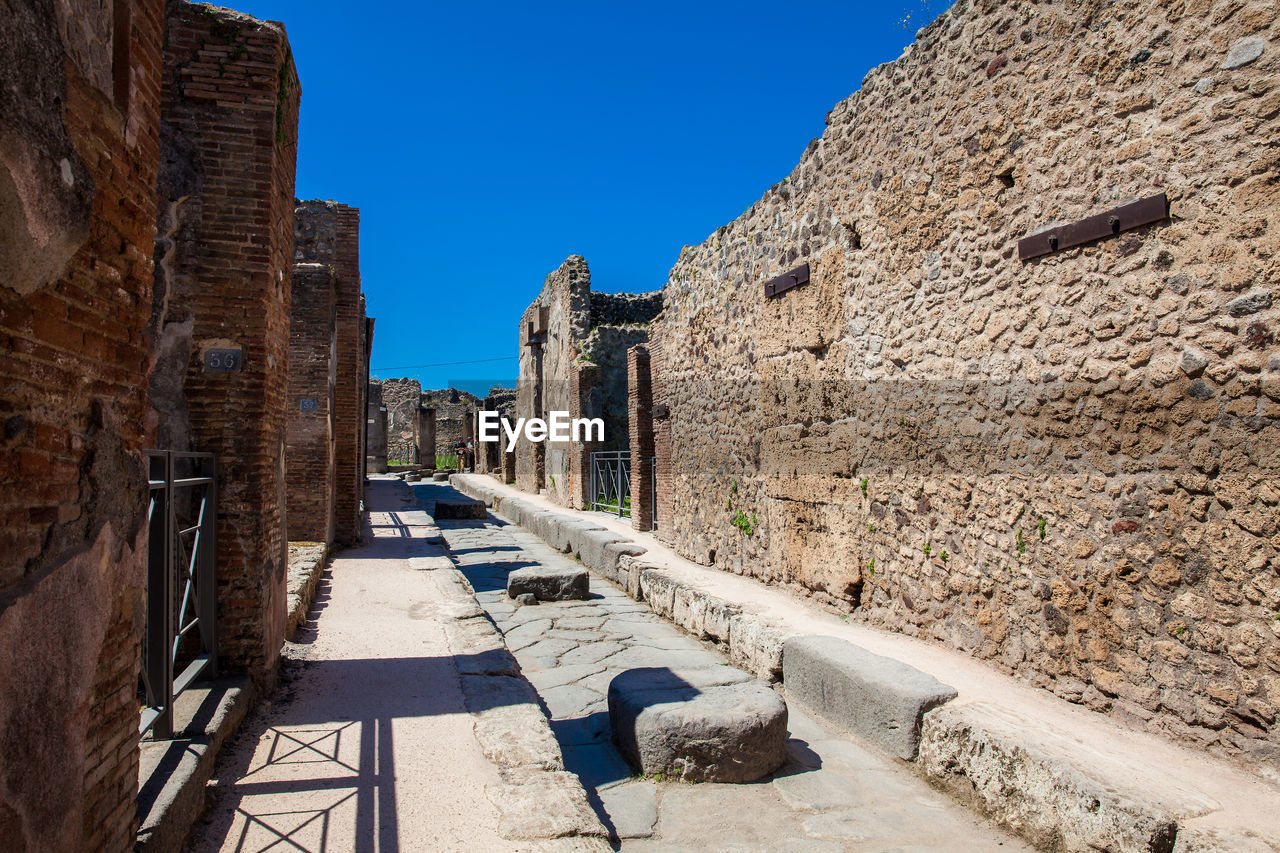 The streets of pompeii made of large blocks of black volcanic rocks
