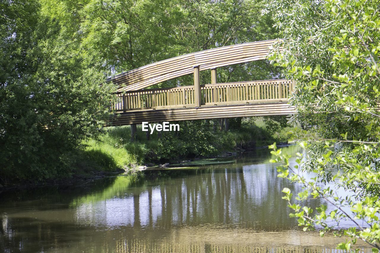 Built structure in lake against trees in forest