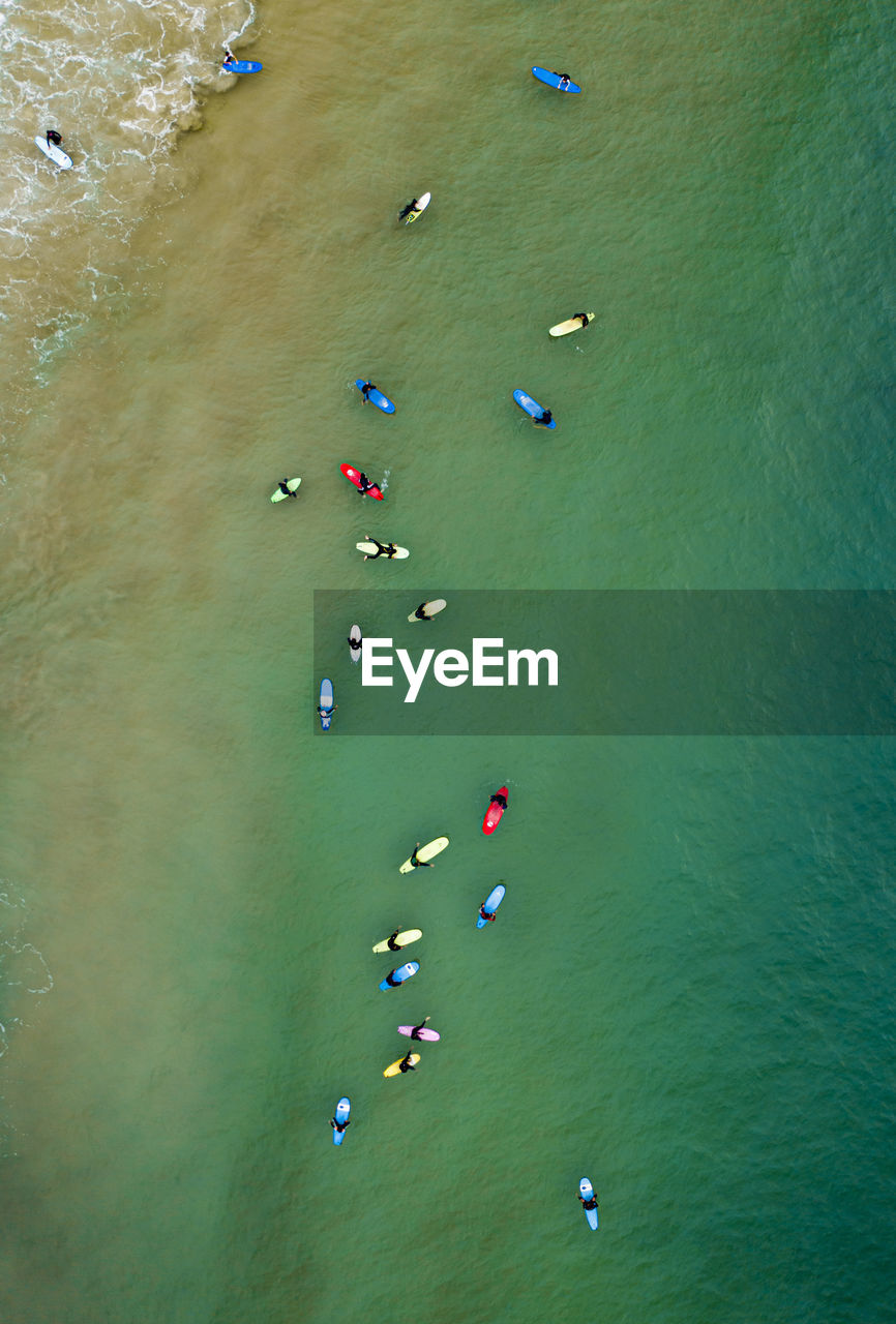 Aerial view of clean ocean waters with surfers