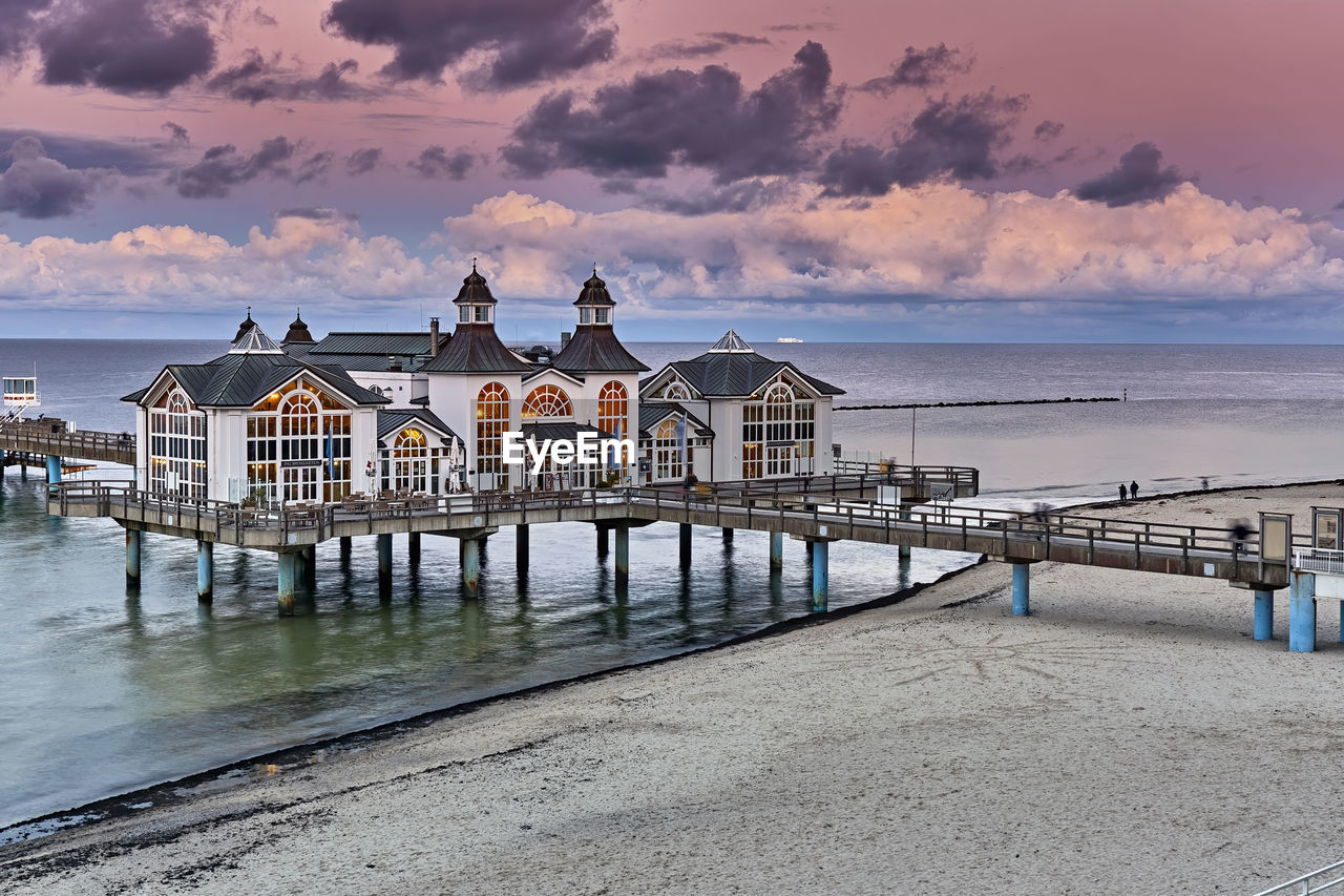 PIER OVER SEA AGAINST SKY DURING SUNSET