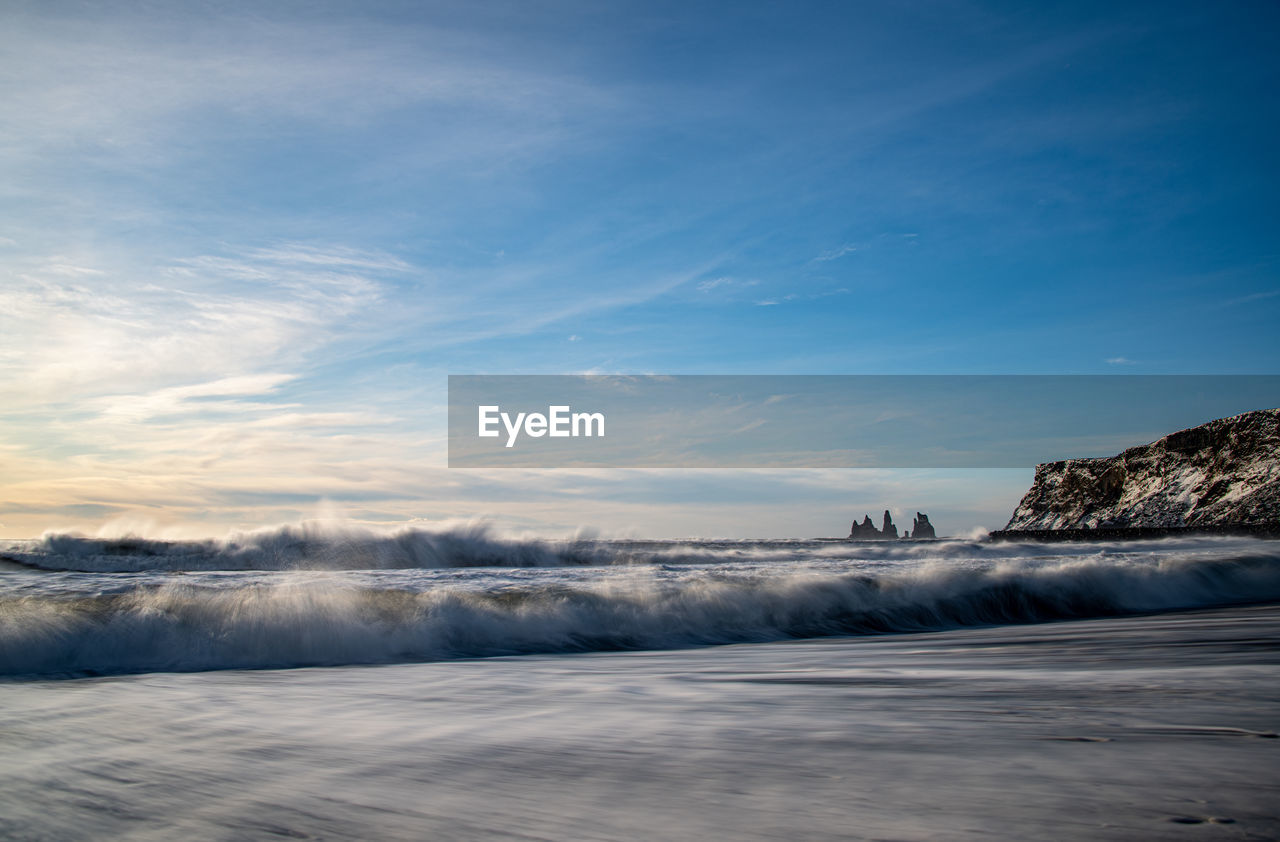 SCENIC VIEW OF FROZEN LAKE AGAINST SKY DURING WINTER
