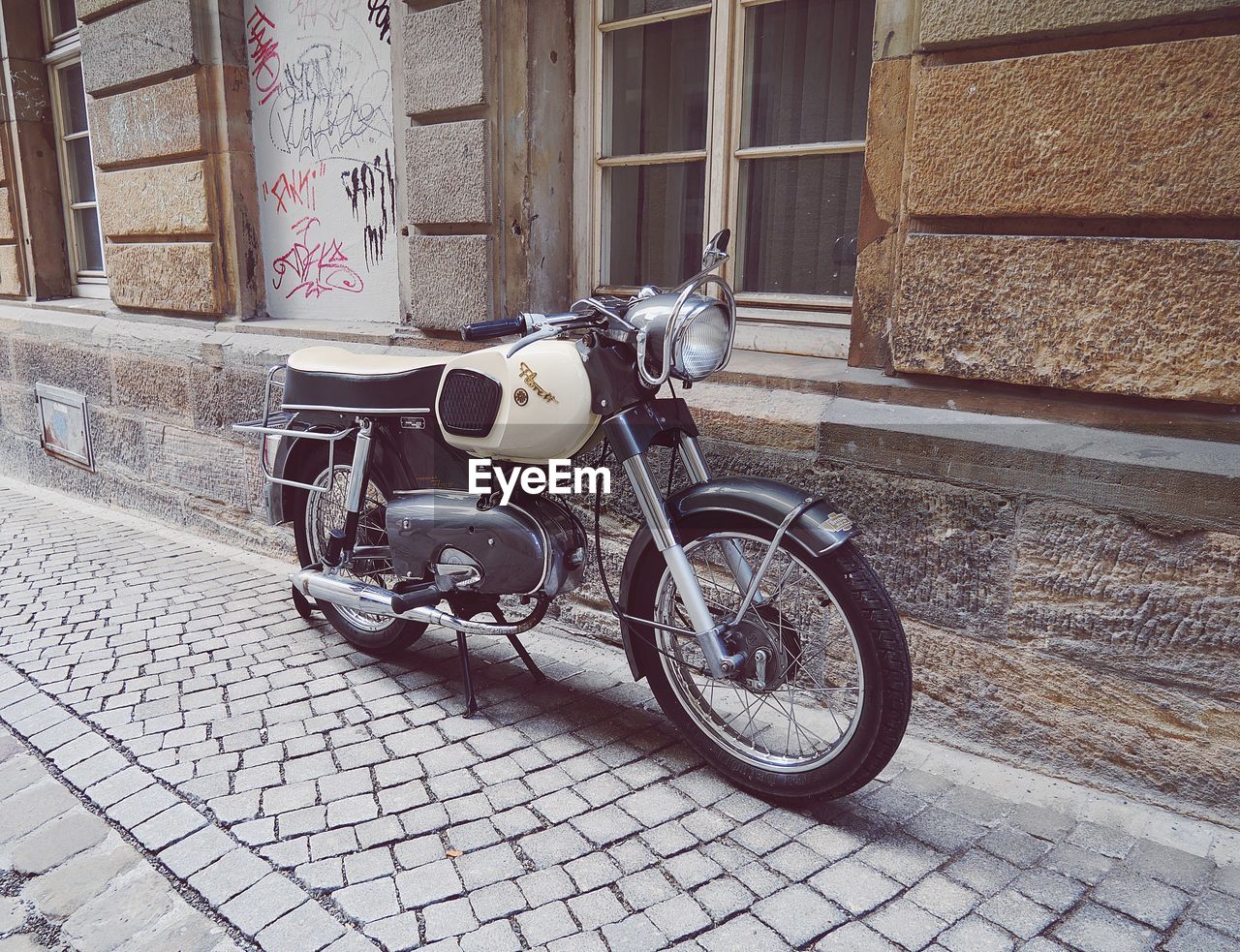 BICYCLE ON STREET AGAINST BUILDING