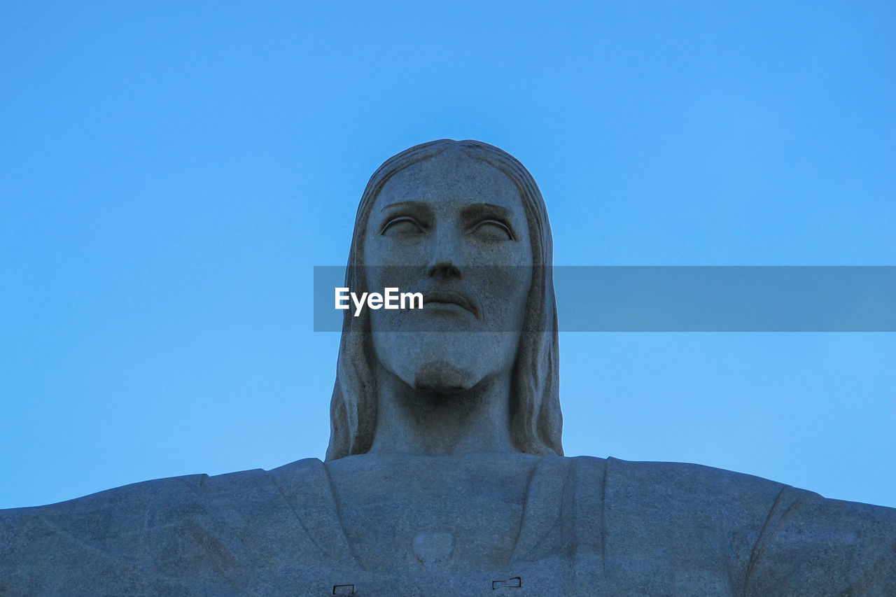 LOW ANGLE VIEW OF STATUE AGAINST BLUE SKY