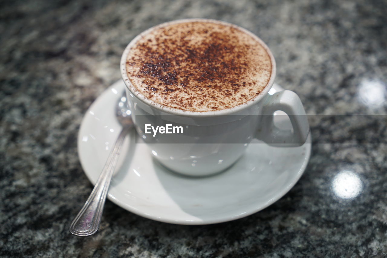 Cappuccino coffee with milk in white ceramic mug