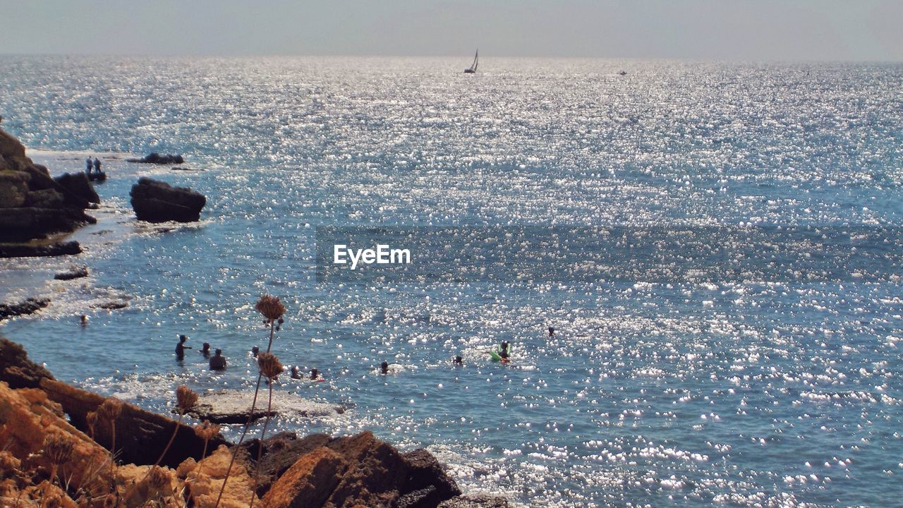 High angle view of rocks in sea against sky