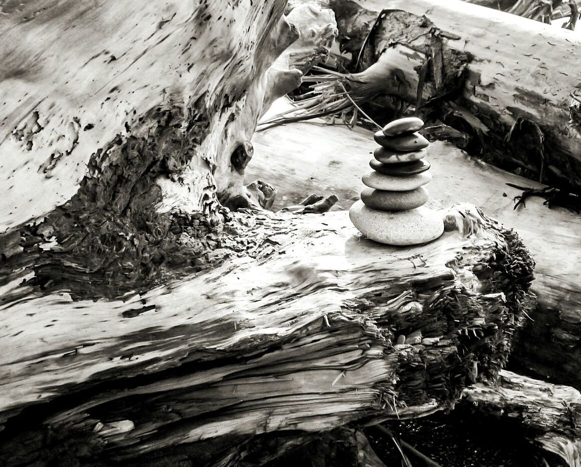 Close-up of stone stack on wood