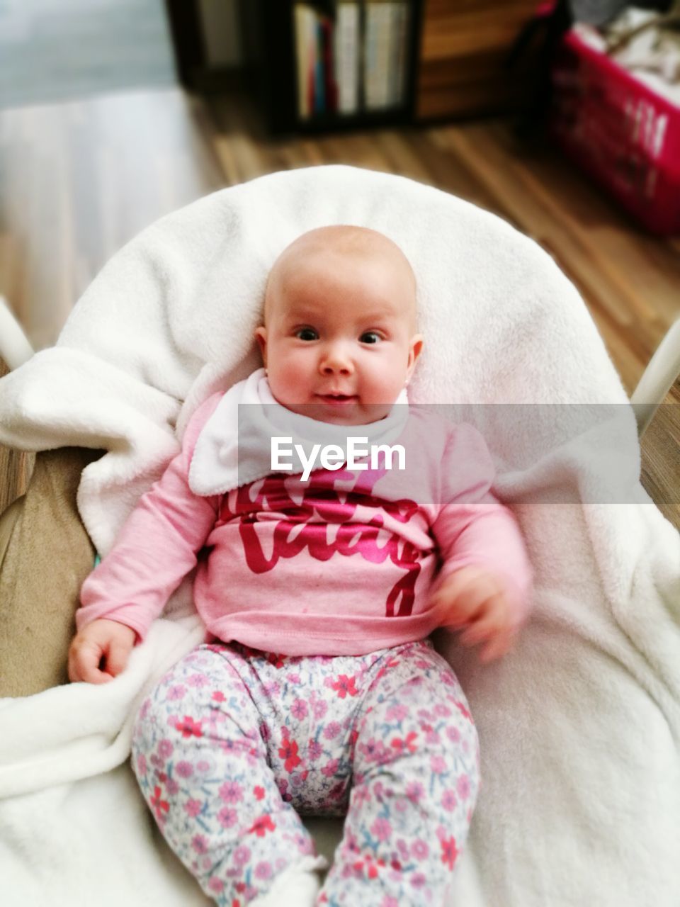 Portrait of baby lying in crib at home