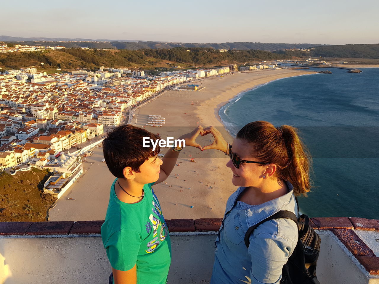 High angle view of boys and sea against cityscape
