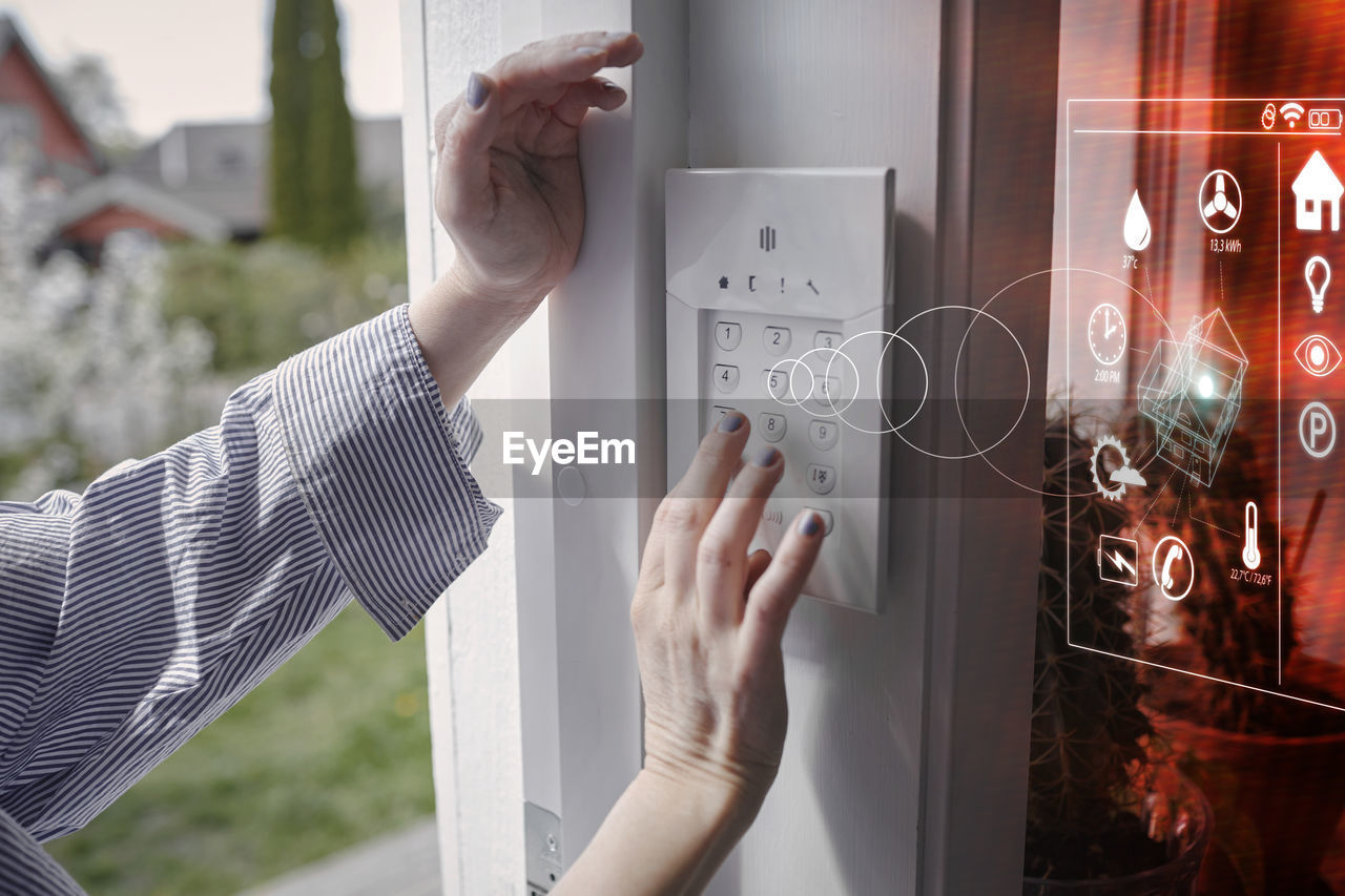 Woman using entry door keypad