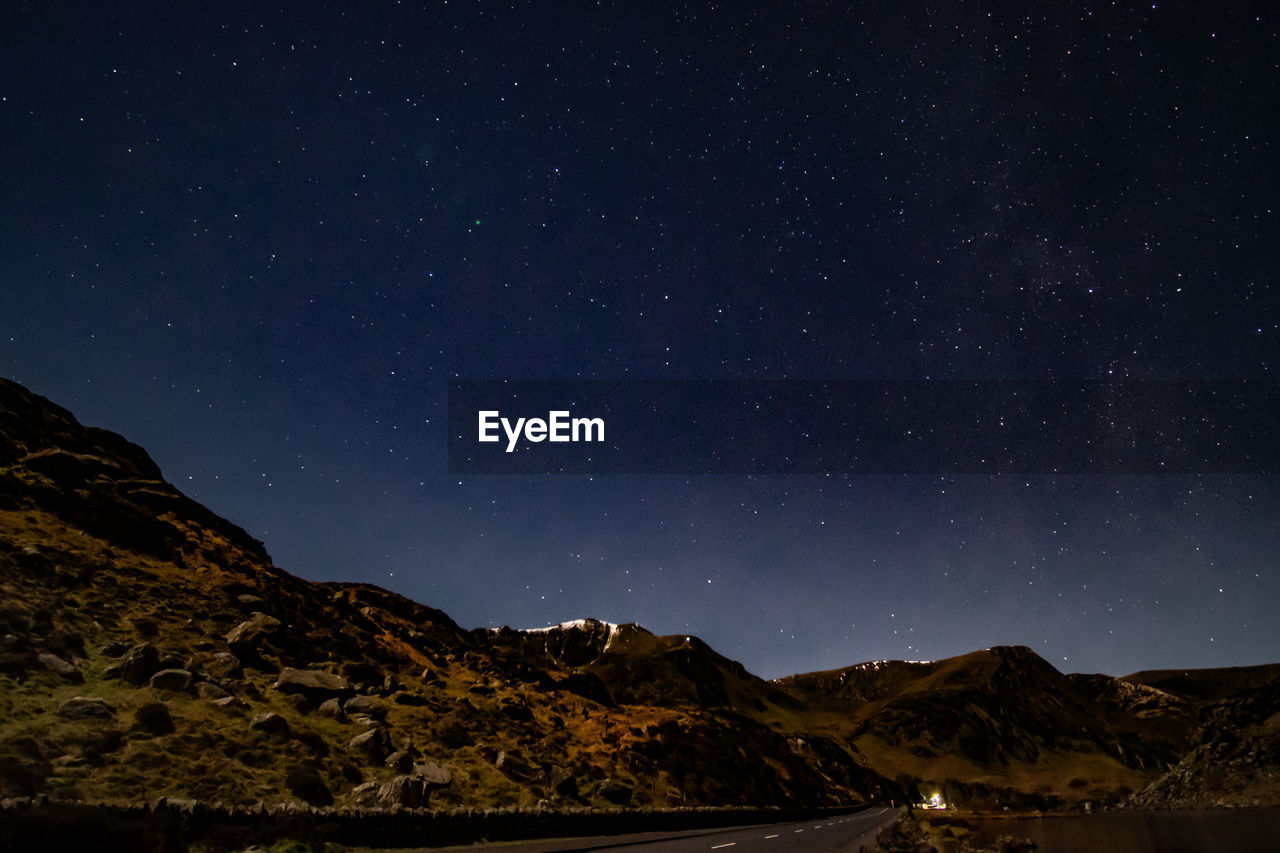 low angle view of mountain against sky at night