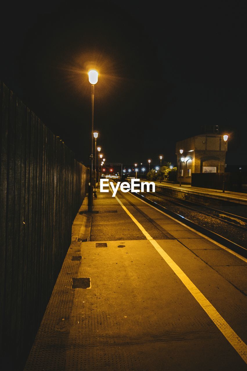 ILLUMINATED RAILROAD TRACK AT NIGHT